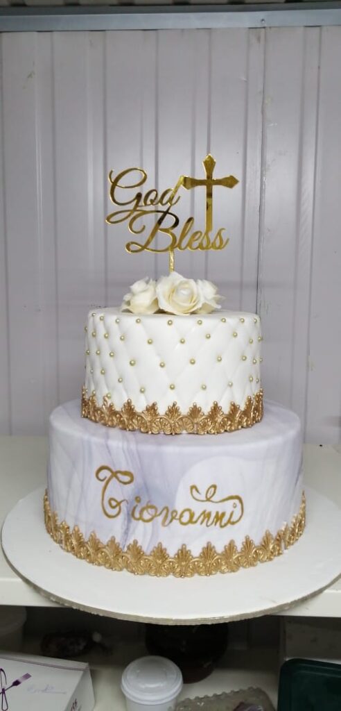 "The Experts Catering and Pastry created a cake with a stunning gold and white design."