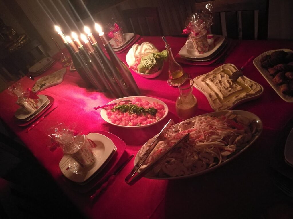 "A table with plates of food and candles, set up by Triple K Catering."