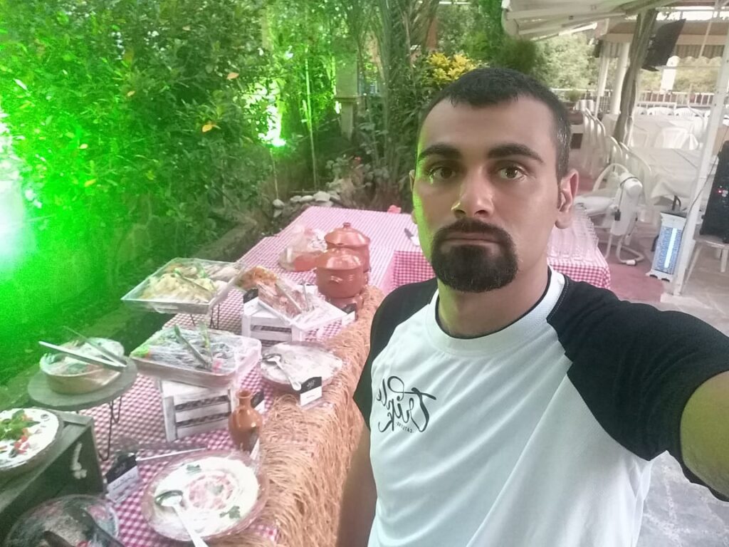 A man taking a selfie with Triple K Catering.