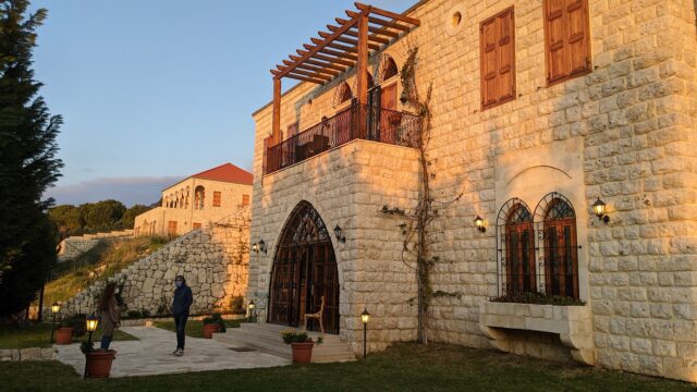 a person standing in front of a stone building