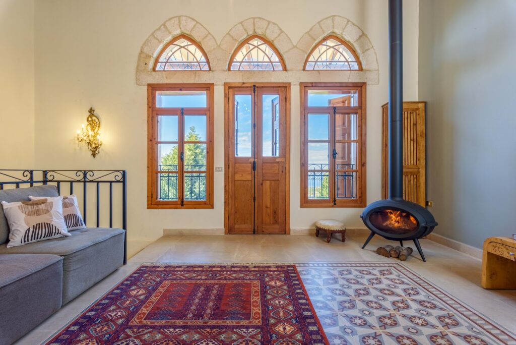 a room with a fireplace and a rug