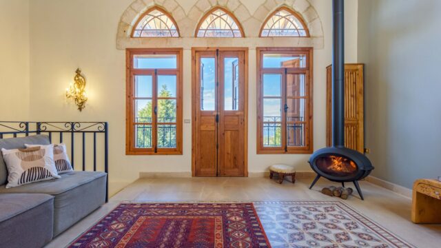 a room with a fireplace and a rug