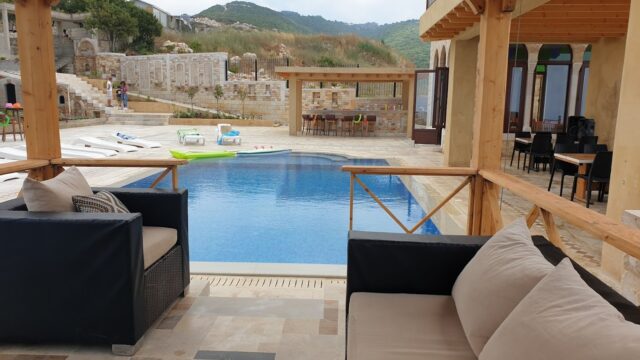 a pool with a couch and chairs