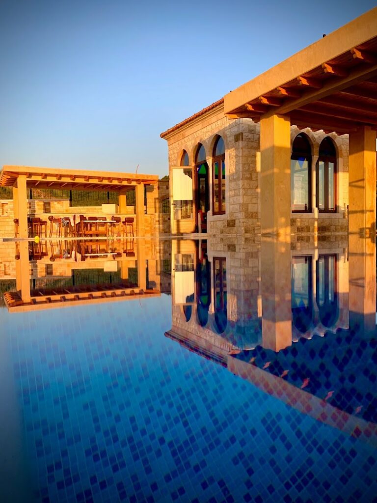 a pool with a building and a pergola