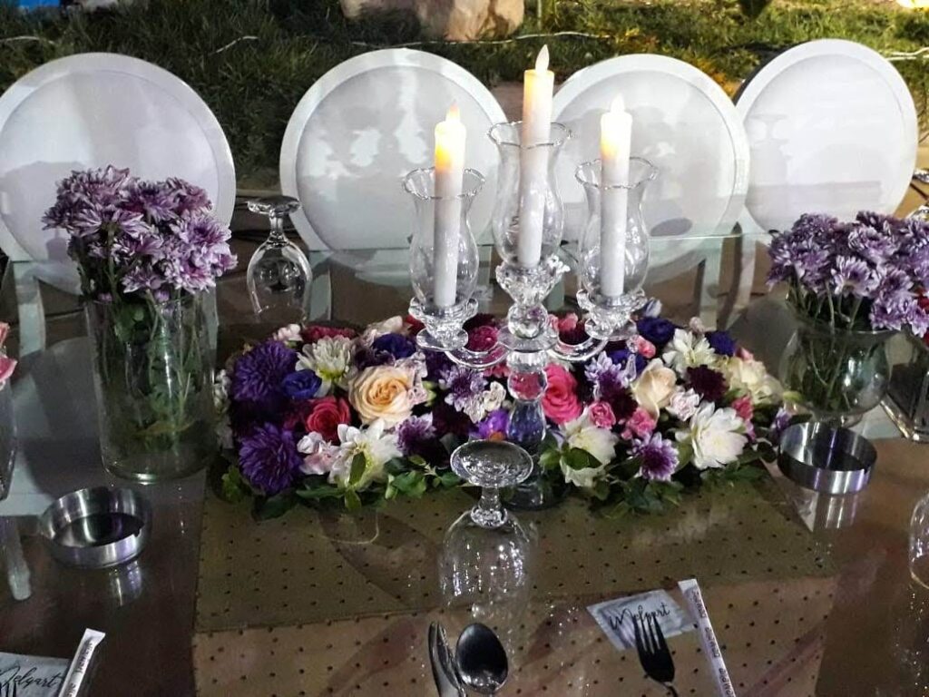 a table with flowers and candles