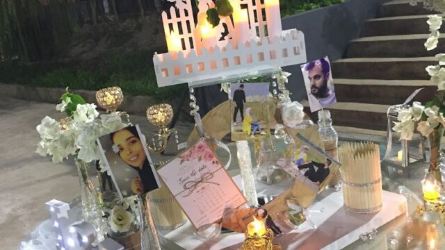 a table with a picture of a couple and a candle