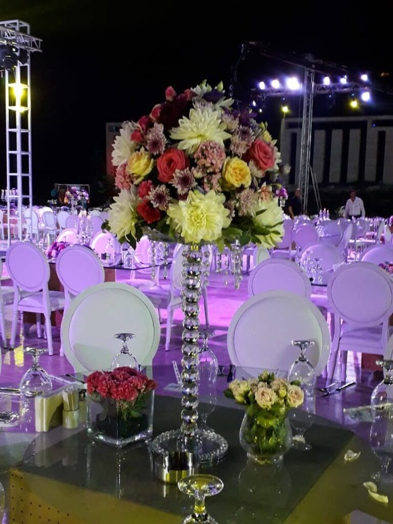 a table set up with chairs and flowers
