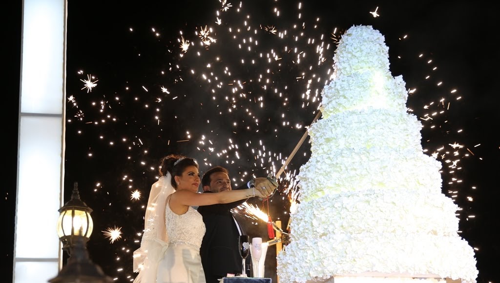 a man and woman cutting a wedding cake