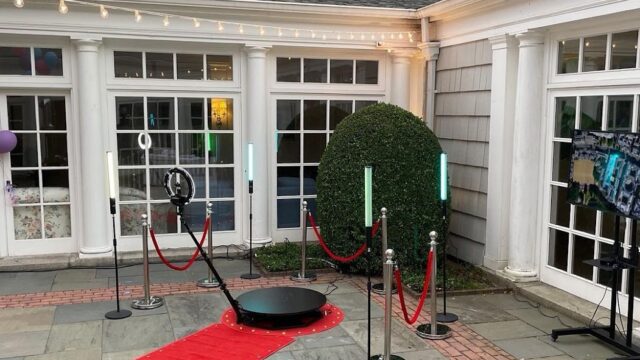 There is a red carpet and rope barriers in front of a house, showcasing an exquisite 360 Photobooth in Lebanon.