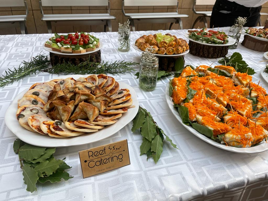 A table with food on it catered by Reef Catering.